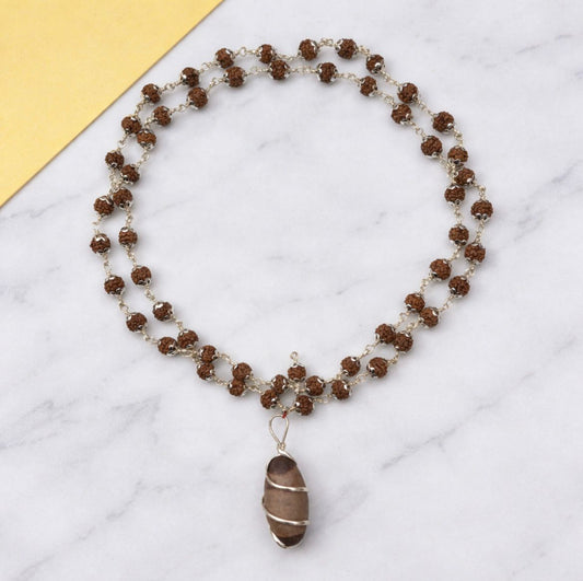 Beaded necklace with a pendant on a marble surface